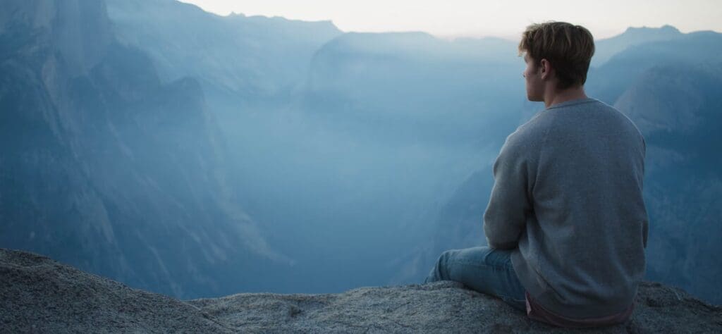 Hero Person sitting on a rock